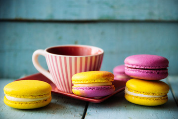 Gentle colorful macaroons on color wooden background