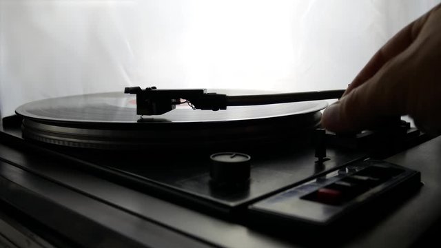 Turn Off Spinning Record Player With Vintage Vinyl. Turntable Player And Vinyl Record With Dropping Stylus Needle Running Old CD And Playing Music on White Background