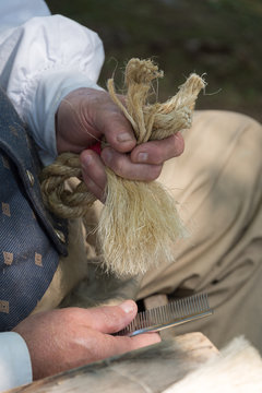 man's hands doing rope craft