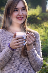 Girl holding a cup of coffee