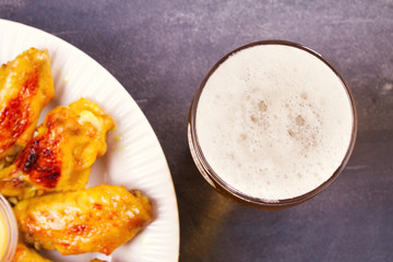 Beer and chicken wings buffalo with cheese dip. View from above, top studio shot, horizontal
