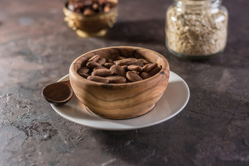 Almond with raisins in a dish of wood
