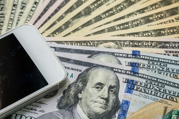 Mobile smartphone on US dollar banknote, digital money concept