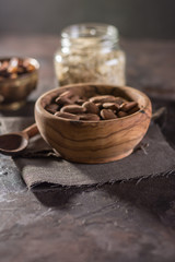 Almond with raisins in a dish of wood