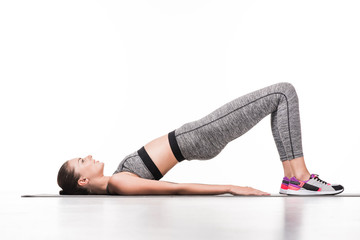 Fototapeta na wymiar sportswoman exercising on yoga mat