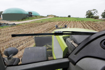 Blick aus dem Trecker auf Maisfeld und Biogasanlage