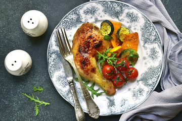 Roasted chicken leg with vegetables.Top view.