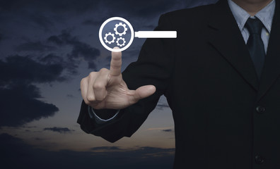 Businessman pressing seo flat icon over sunset sky, Search engine optimization concept