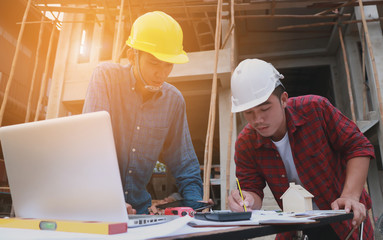 Two Engineers in meeting for architectural project. working with partner and engineering tools .digital tablet on workplace vintage tone.