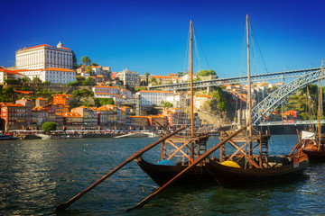 Day scene with Ribeira embankment, Douro river and traditional port wine boats, Porto Portugal, retro toned