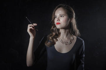Obraz premium Noir film style woman in dress holding cigarette. Black and white photography. Old fashion photo