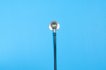 Medical stethoscope on blue background.