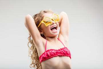 Vivacious fun little girl wearing trendy glasses