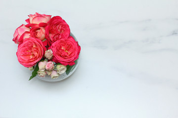 Bouquet of roses on the marble. top view. flat lay