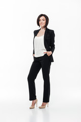 Full length portrait of a brunette businesswoman in a suit
