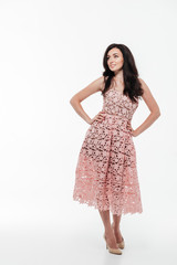Full length portrait of a young brunette woman in dress