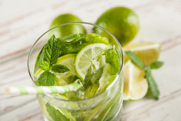 Mojito cocktail on white wood background