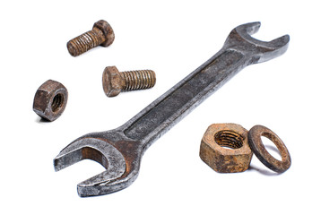Shabby spanner and rusty nuts, bolts on white background