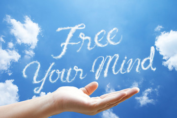 “Free Your Mind”cloud word floating on upturned hands.
