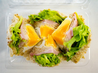 Egg ham and vegetable wholewheat bread sandwich for fast food for breakfast.