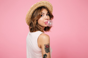 Portrait of a cute young girl in summer hat looking at camera