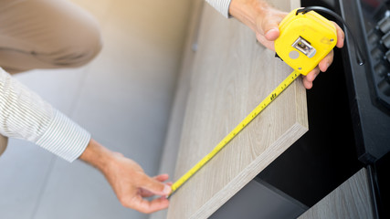 Architect taking measures of a brand new kitchen. Home style and design concepts