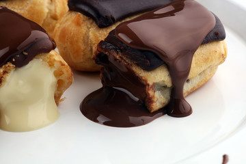 Traditional French dessert. Eclair with chocolate icing. Pastery concept