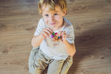 Young boy play with fidget spinner stress relieving toy