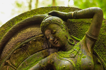 Statue of Goddess naked chest There are green moss on the body.
