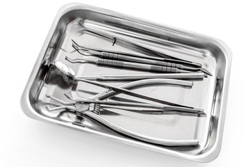 Basic dentists tools in cuvette on   white background