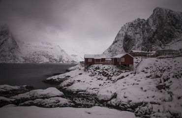 Fishing village of Hamnøya, Moskenes commune, Lofoten, Norway. Northern Norway in winter. Picturesque houses of red color are typical architecture on the Lofoten islands.