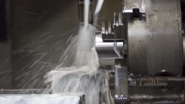 the CNC machine making the part from metal