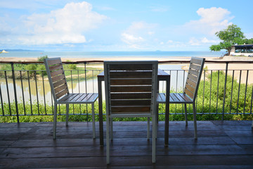 Restaurant tables on a tropical resort with blue sky and nice beach