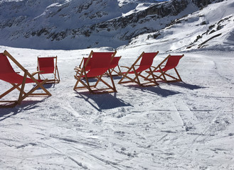 Winter sunbathing, deck chairs in the snow