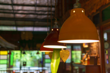 Colorful lamps hanging on the ceiling are turn on.