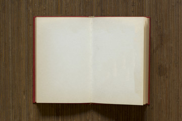A white open book on a brown mat