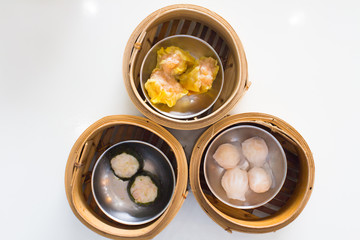 Top view fresh dumplings with hot steams on wood plate .Chinese food