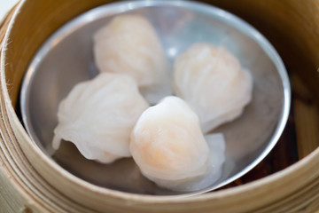 Fototapeta na wymiar Top view fresh dumplings with hot steams on wood plate .Chinese food