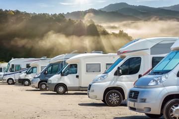 Close up motorhomes parked in a row with fog in the morning background, Chiang Mai Province,...
