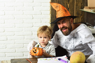 Fototapeta premium Man in orange hat and kid with happy, interested faces
