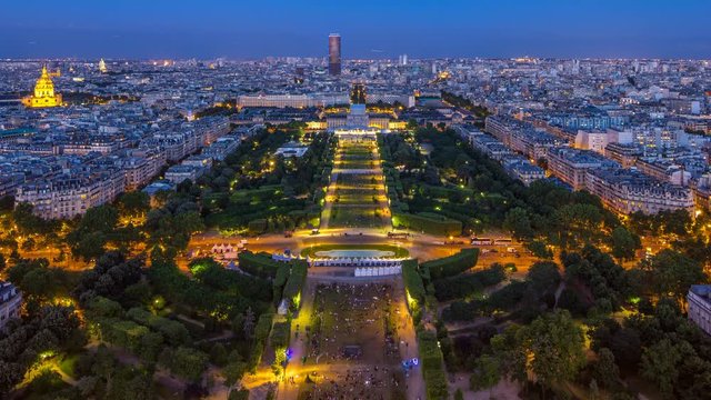 Aerial view of a large city skyline after sunset day to night timelapse. Top view from the Eiffel tower. Paris, France.