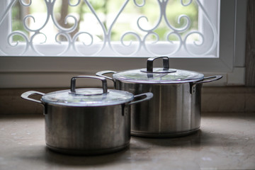 old aluminum stainless steel cooking pot on kitchen table