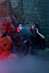 Halloween Holiday witch with a broom and a sorcerer in a hat