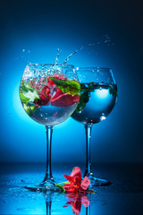 flowers in a bowl with water on a blue background
