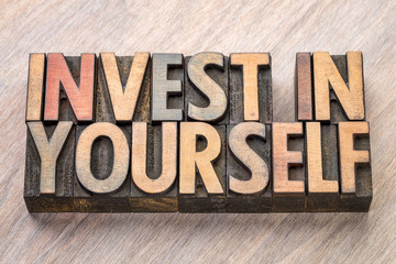 Naklejka premium invest in yourself word abstract in wood type