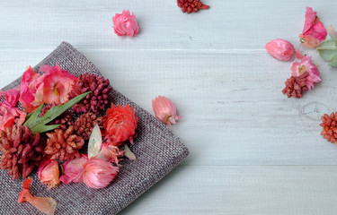 Dried fragrant flowers for conditioning placed on wooden vintage table