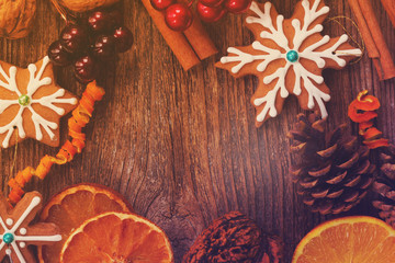 frame with christmas gingerbread snowflake cookie with spices and decorations close up, retro toned