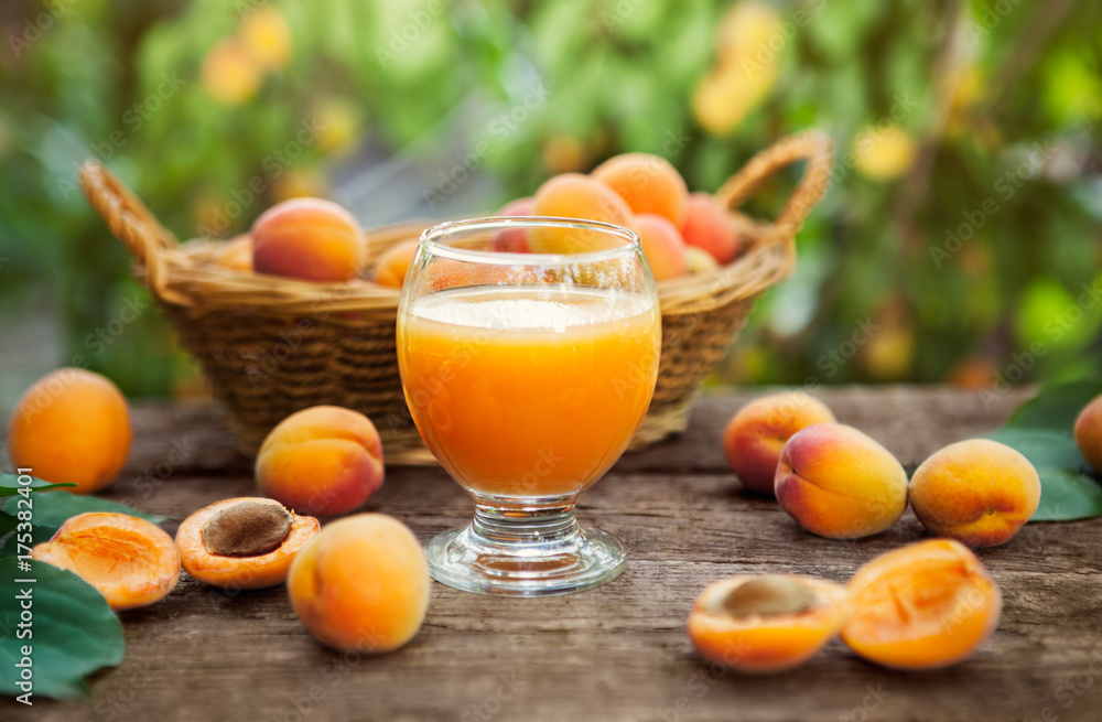 Wall mural Glass with apricot juice and apricots