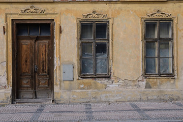 Fototapeta na wymiar Old building with old windows and door, Europe