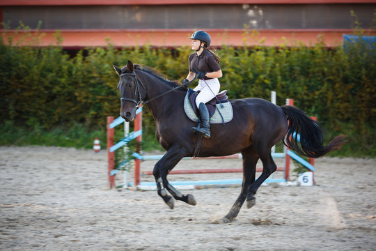 Horsewoman is riding on the competition outdoors